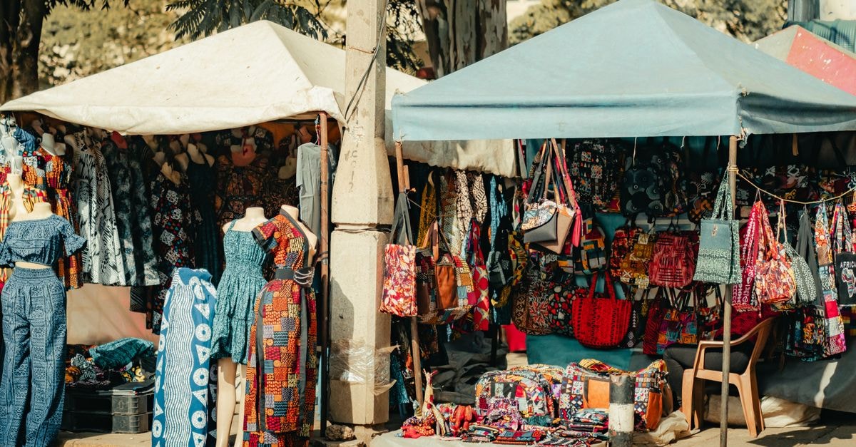 Kajiado travel guide: markets, plains and Kenya-wide flavors Colorful textile and fashion stalls in a Nairobi market, showcasing diverse African patterns and designs.