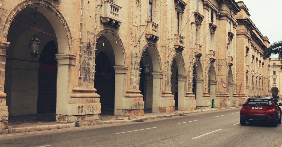 Zabbar Travel Guide: Heritage Streets and Southern Malta Calm Vintage facade with arches in Valletta, Malta, showcasing classic architecture.