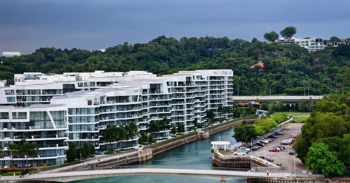Batam Travel Guide: Island Ease Between Singapore and Sumatra Aerial view of contemporary buildings by the water in Singapore with lush greenery in the background.
