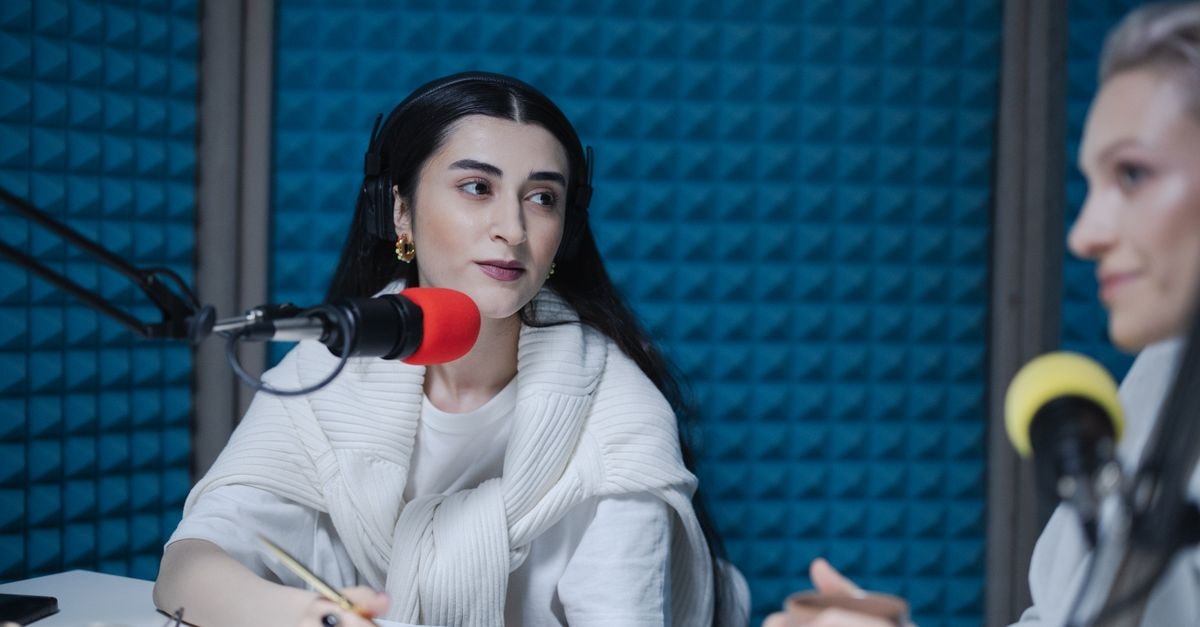 Gabbi Garcia joins 'The Voice Kids' as Journey Host for new season Two women engaged in a podcast recording with professional microphones, soundproof studio.