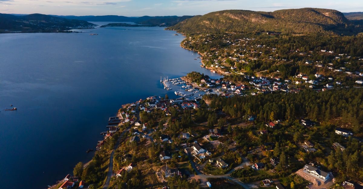 Breathtaking aerial view of Viken's coastline and peaceful residential area at dusk.