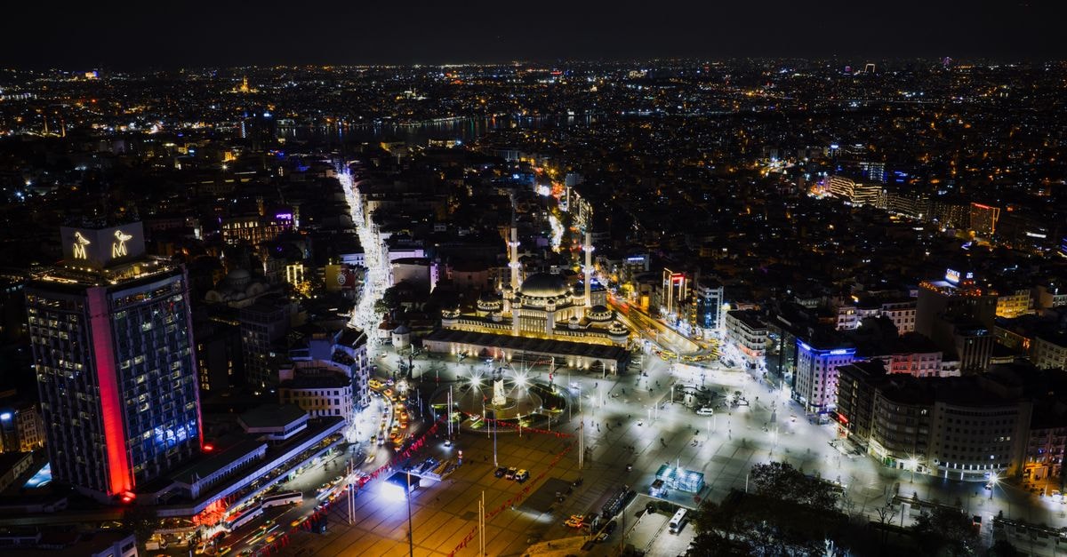 Real Konak Hotel in Batman: Central Stay with Spa and City Views Aerial view of Taksim Square in Istanbul at night, showcasing city lights and bustling streets.