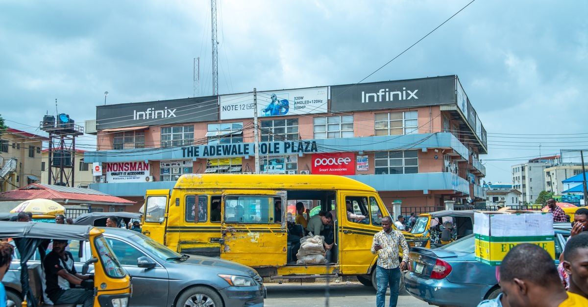 Ajegunle, Lagos: An Honest Travel Guide to a Working Lagos District Vibrant urban life in Lagos with traffic and pedestrians by The Adewale Kola Plaza.