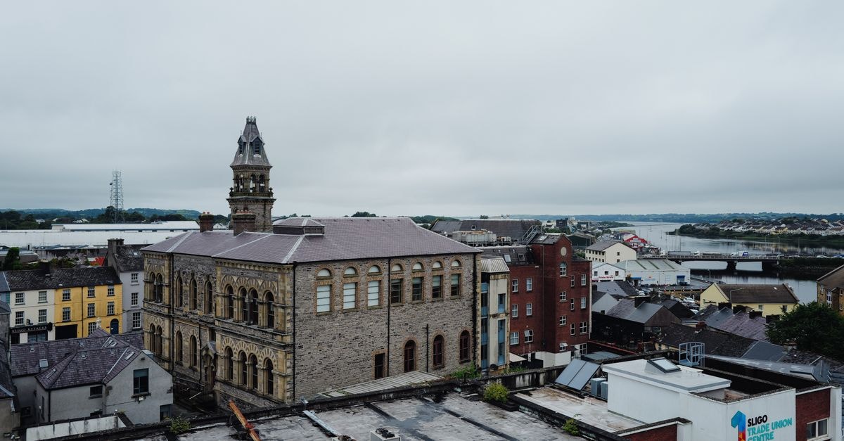 Iona Inn in Londonderry: A Waterside Guesthouse Steps from Craigavon Bridge Aerial view of historic architecture in Sligo, Ireland with scenic landscape background.