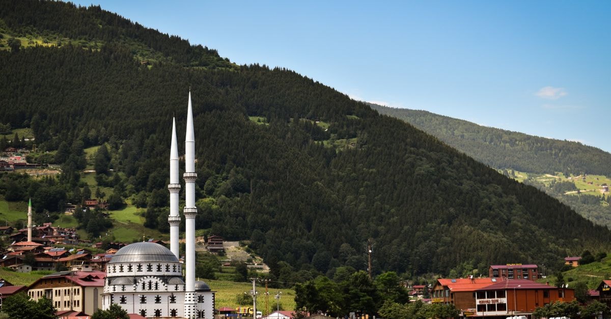 Trabzon Travel Guide: Planning Tips, Costs and Things to Do Picturesque Uzungöl Mosque with lush mountains in the backdrop, a serene and captivating view.