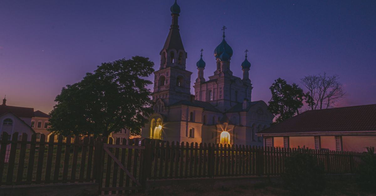 Pskov Travel Guide: Planning Tips, Costs and Things to Do Captivating view of a church in Vetvenik, Russia at twilight, showcasing architectural beauty.