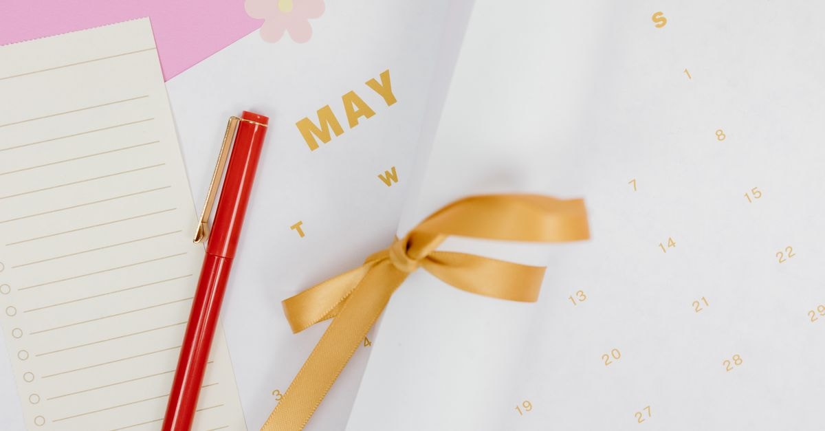 Bridge Palm Hotel, May Pen: A Countryside Oasis Between Two Towns A minimalist flat lay of a calendar with red pen and ribbon on a pink background, perfect for planning.