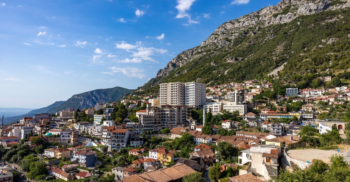 Delcevo travel guide: a quiet Macedonian town between mountains Picturesque view of Krujë city nestled against mountains in Albania under a clear blue sky.