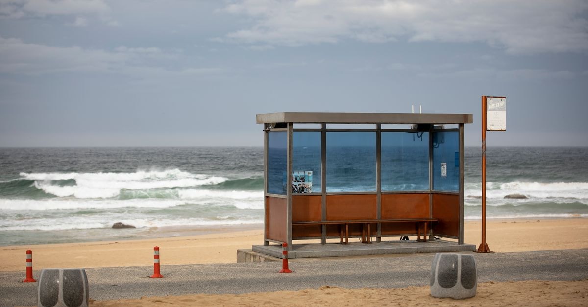A solitary bus stop by the sea on a cloudy day in Gangneung-si, South Korea.