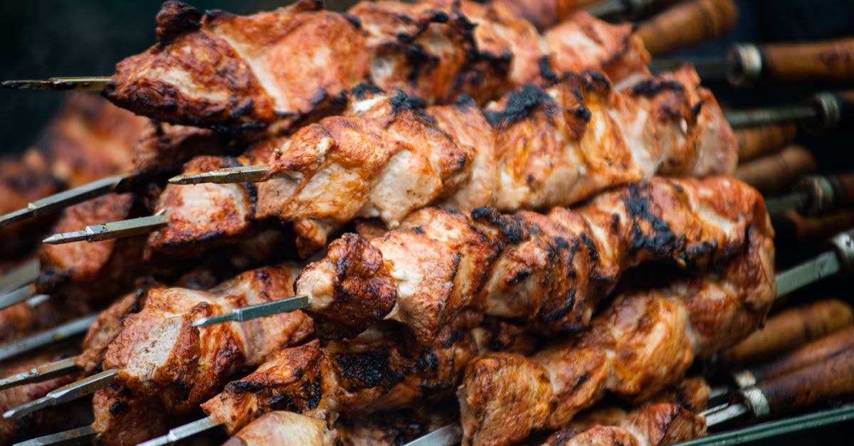 Juicy grilled shashlik skewers stacked outdoors, showcasing vibrant barbeque textures in Moldova.