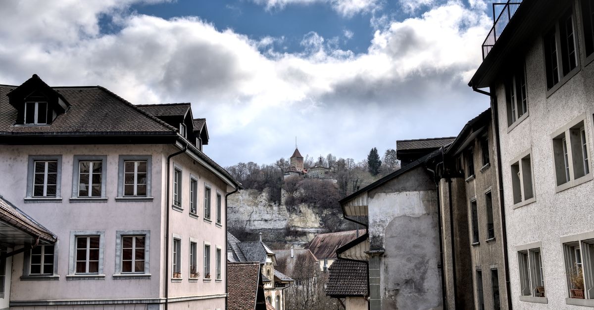 Hotel Central, Fribourg — A Hauptstrasse Address in Düdingen Charming view of Fribourg's old town with vintage architecture and scenic backdrop.