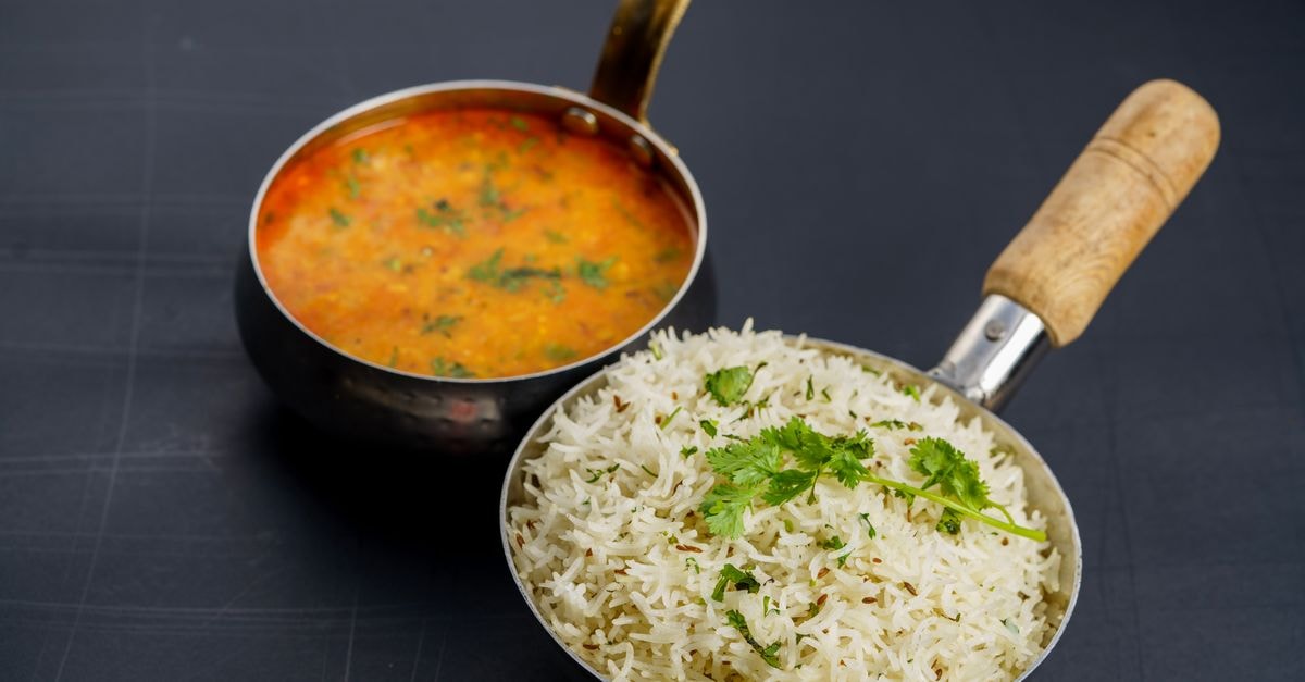 Hotel Seventh Sense, Nagpur — A Boutique Stay in the Orange City A top-down view of Indian rice with dal curry in pans. Perfect for authentic Indian cuisine themes.