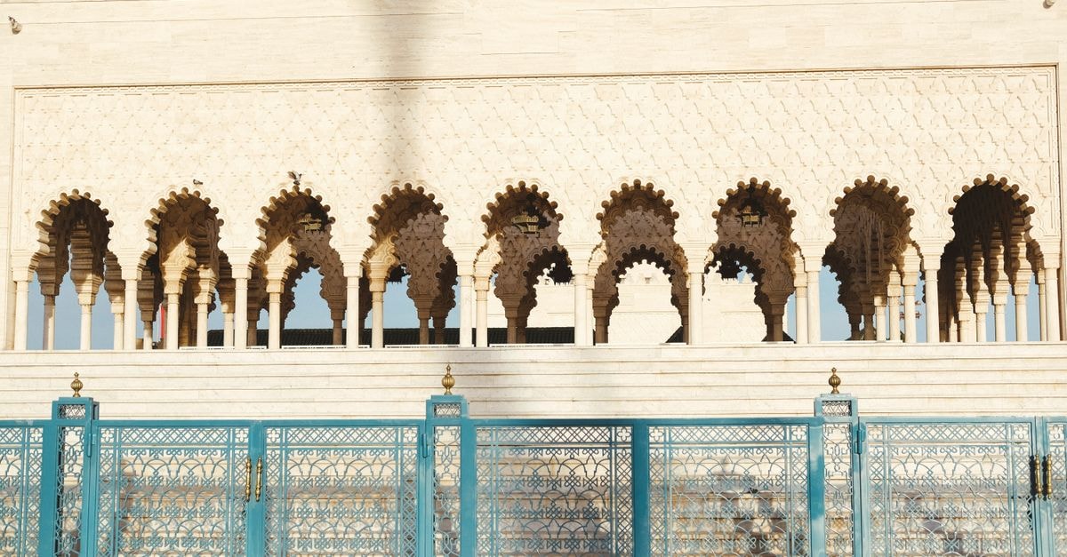 Stunning view of Hassan Tower's intricate arches and blue gates in Rabat, Morocco.