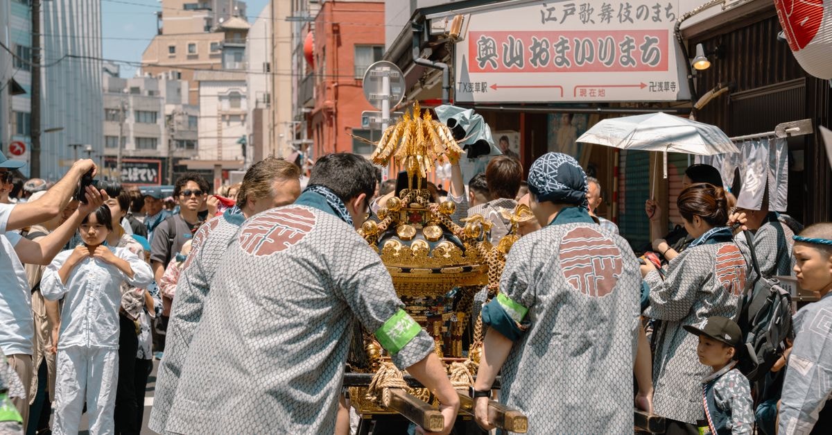 Crowded street scene at a vibrant traditional festival in Tokyo, Japan.