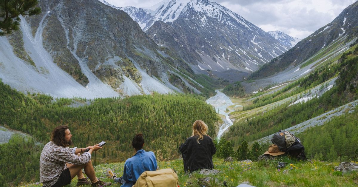 Sunshine Holiday Hotel in Altay: A Cultural Road Address Worth Knowing Explore stunning views of the Altai Mountains with hikers enjoying the serene landscape.