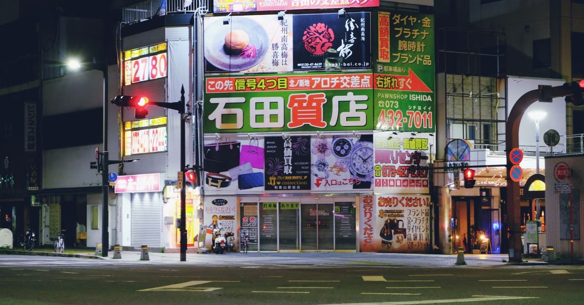 Toyonaka Travel Guide: A Quiet Osaka-Side Base Worth Knowing Vivid urban nightlife in Osaka with illuminated signs and quiet streets.