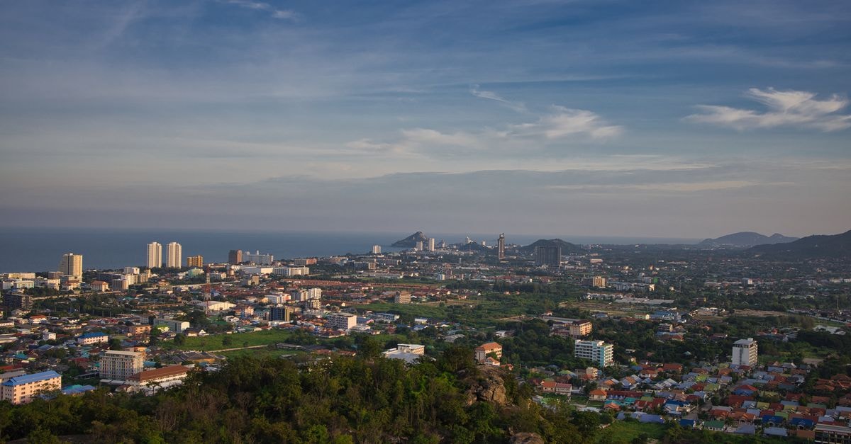 Panoramic aerial view of Hua Hin, Thailand with cityscape and ocean in the distance.