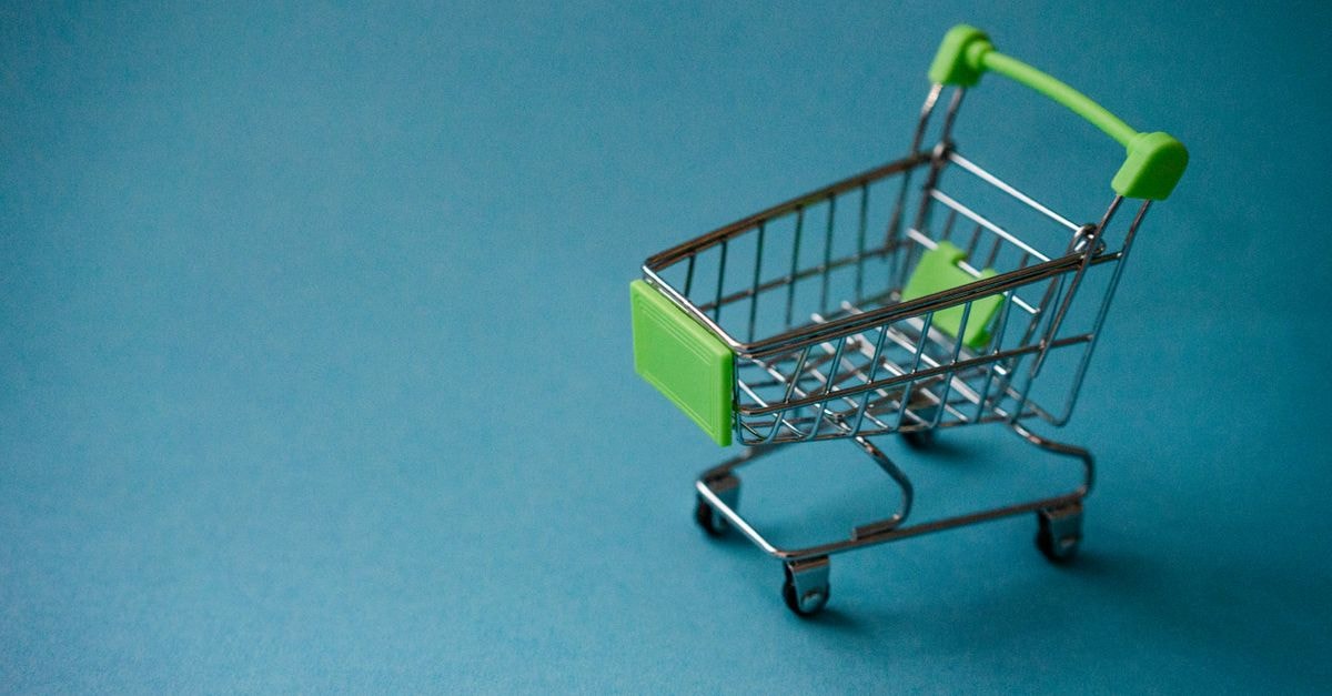 Equinor Issues Corrective Buy-Back Update on Employee Share Programme A miniature shopping cart with green accents on a blue background, perfect for retail concepts.
