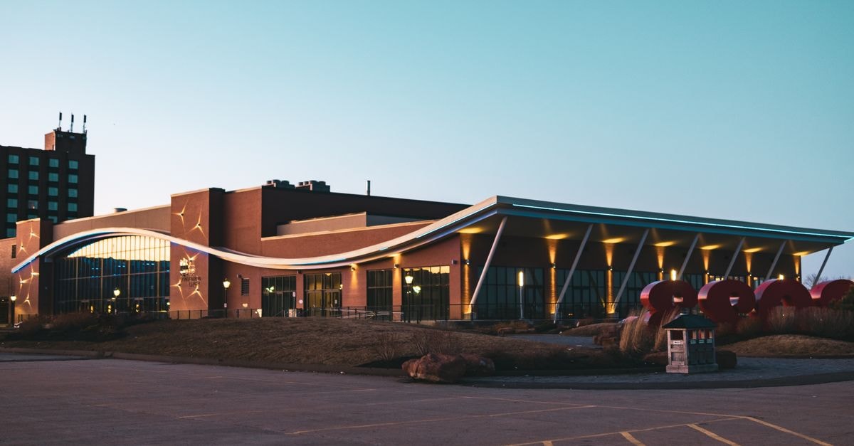 Rodd Charlottetown Hotel in Charlottetown: Heritage Elegance on Kent Street A modern urban building with distinctive architecture captured at twilight against a clear sky.