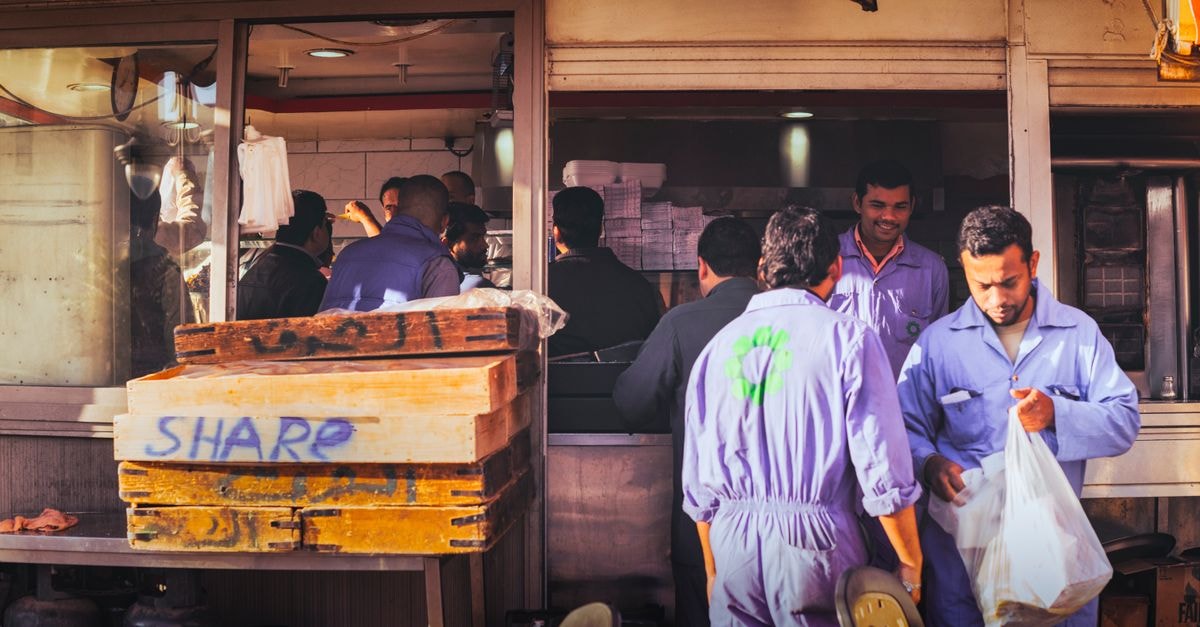 Aleppo Travel Guide: Moving Carefully, Eating Well Construction workers taking a lunch break at a restaurant in Dubai.