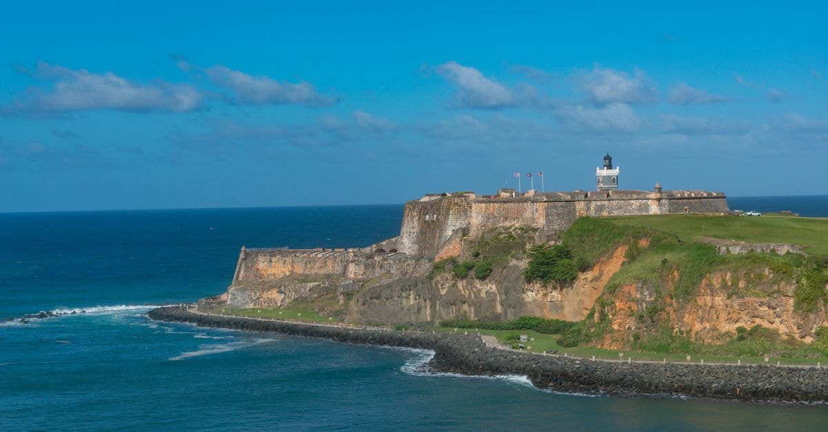 Explore the majestic El Morro fortress set against a vibrant blue ocean in Puerto Rico.