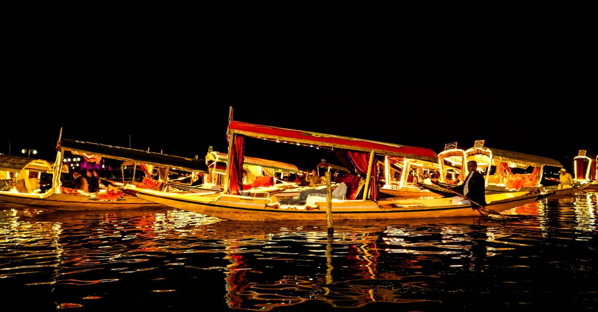 Kashmir preps first international film festival; 'Chaar Diwaari' heads to Fantasia Vibrant night scene of illuminated boats reflecting on a calm river.