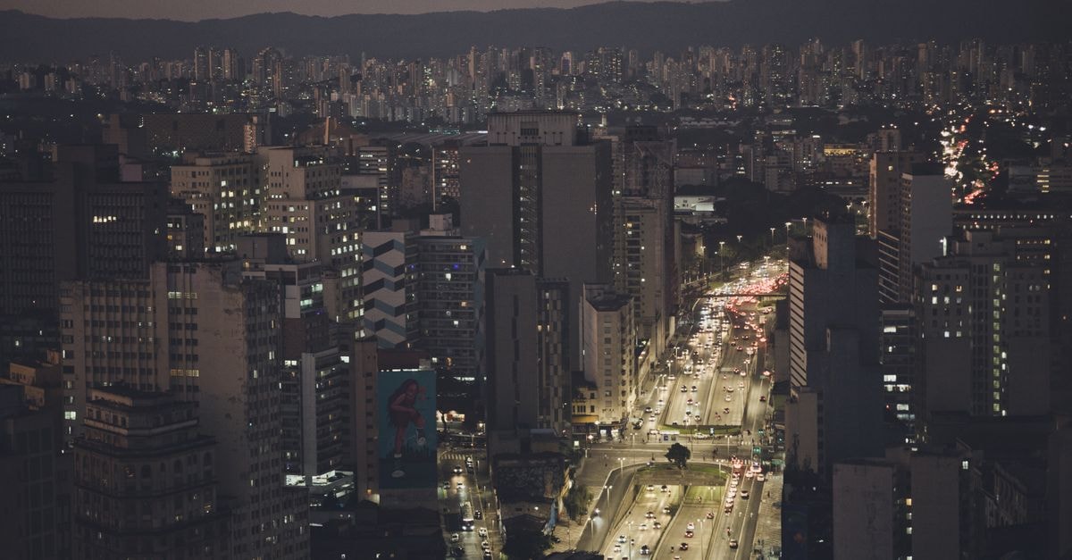 Hotel in Betim, Brazil: Industrial Roots and Historic Echoes Aerial view of São Paulo's downtown with illuminated streets and skyscrapers at night.