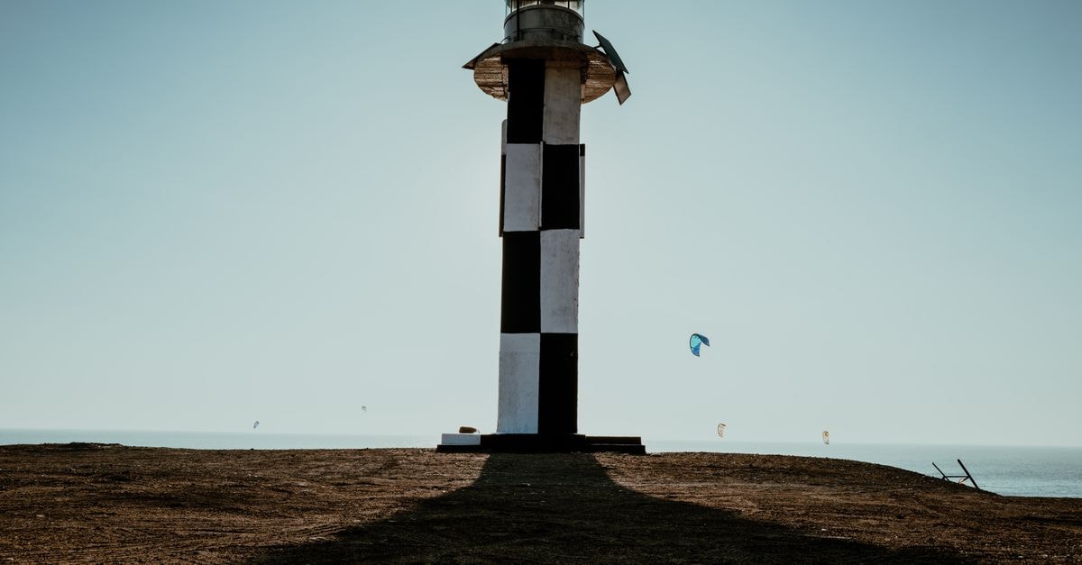 Dramatic lighthouse silhouette against the blue sky along Pacasmayo beach, Peru.