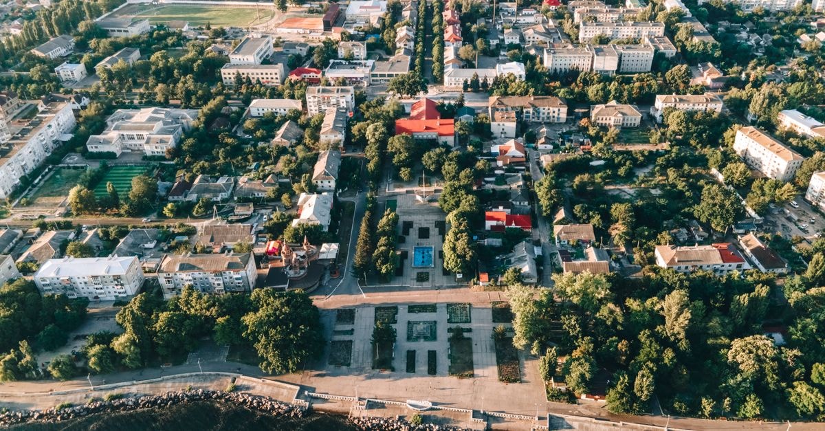 Avalon Palace in Ternopil: A Central Spa and Stay in the Heart of the City Stunning aerial shot of a bustling city surrounded by greenery and waterfront.