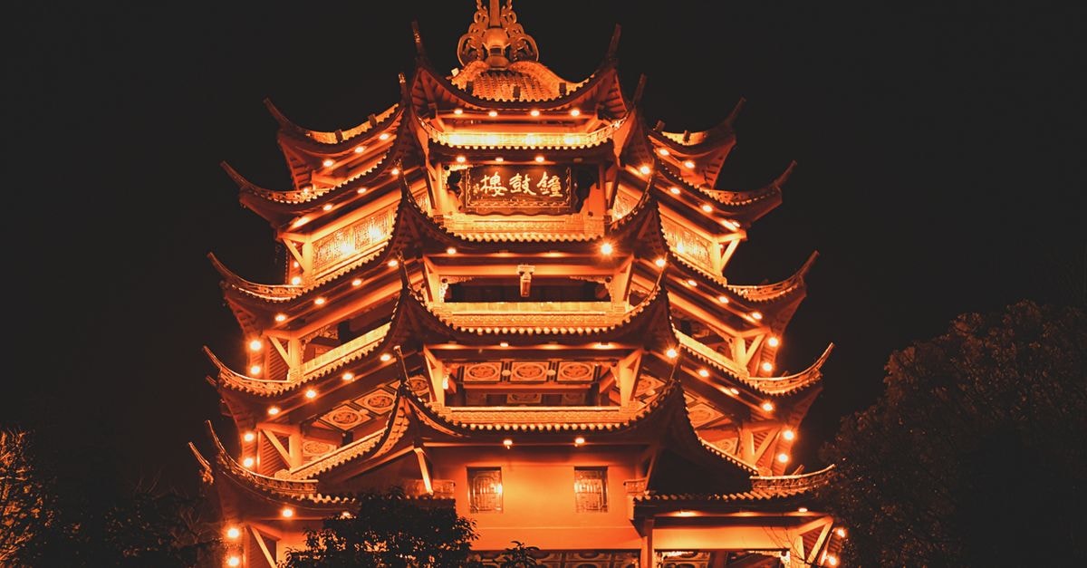 Beautifully illuminated traditional Chinese pagoda at night in Sichuan, China, showcasing intricate architecture.
