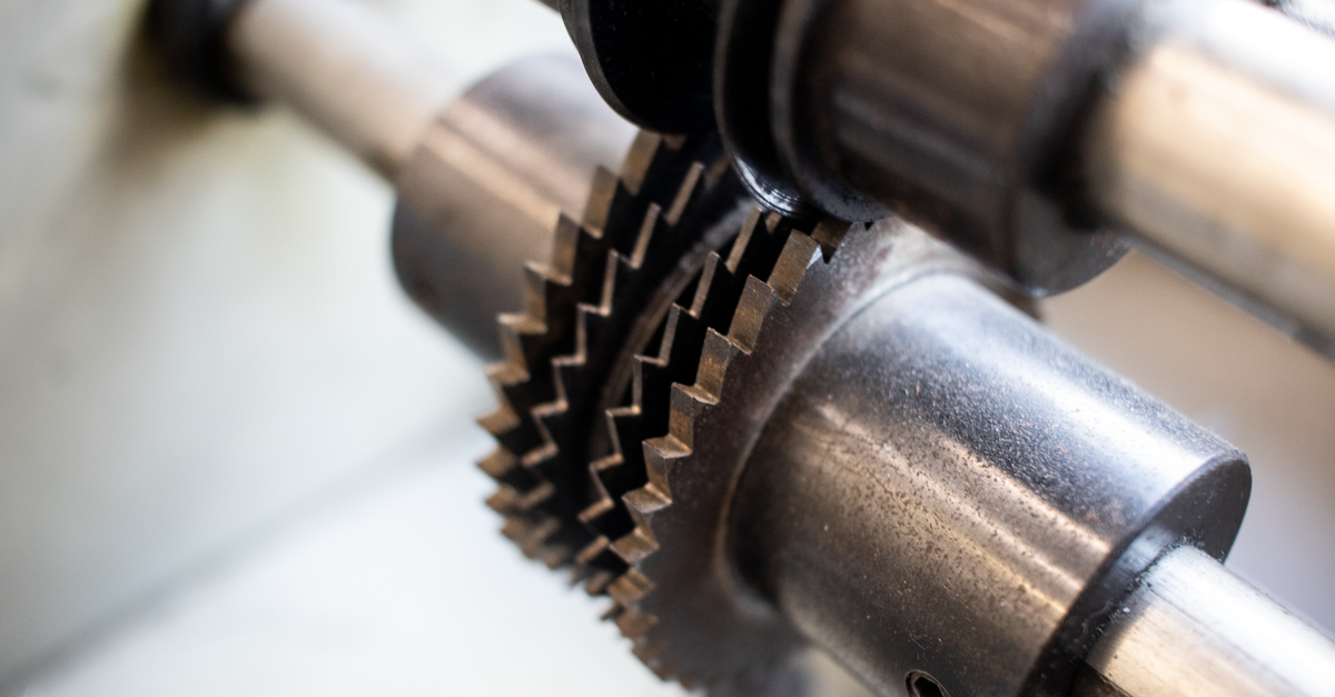 Onto Innovation: Premium Multiple on a Specialized Equipment Franchise Detailed view of interlocking metal gears in industrial machinery.