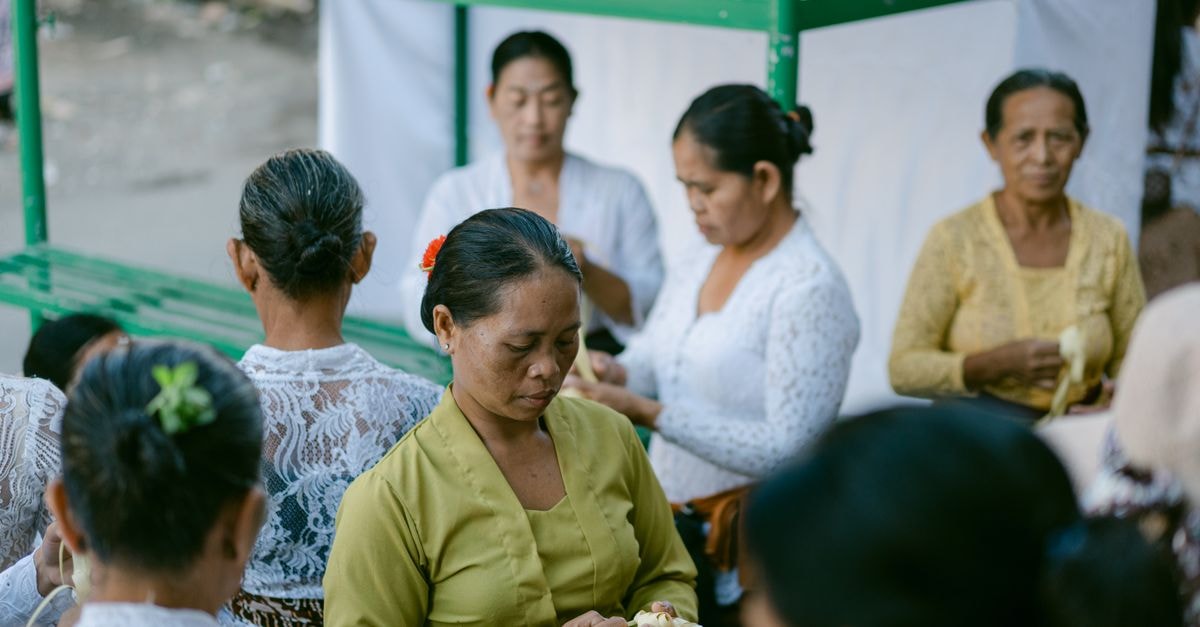 Denpasar travel guide: slow days in Bali's cultural capital Women in traditional Balinese dress participate in a cultural ceremony.