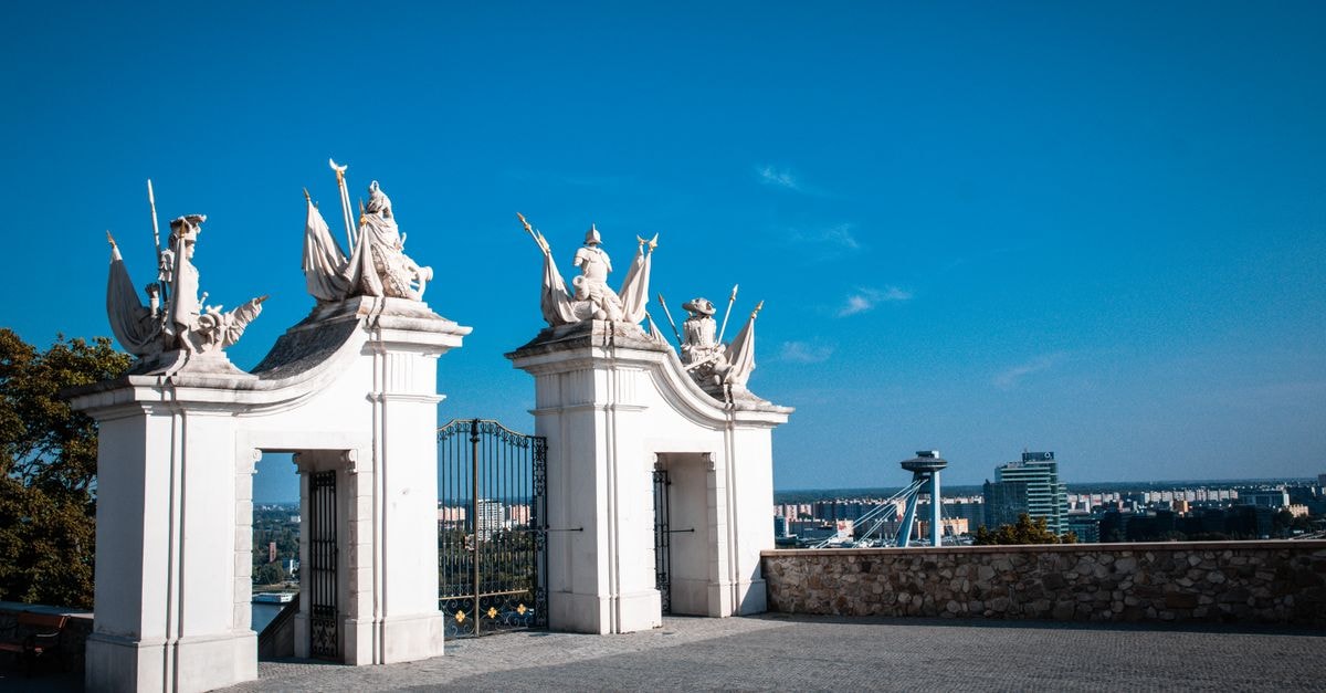 VIP Apartments in Bratislava: Old-Town Stay Above a Historic Gate Scenic view of Bratislava with an elegant castle gate, capturing a blend of history and modernity.