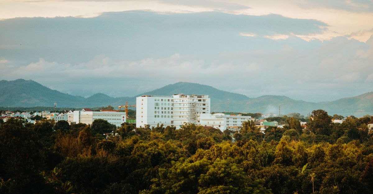 Central Park Hotel, Tarlac City — A Countryside-Stylish Stay Inside Luisita Business Park Beautiful view of Kon Tum, Vietnam featuring lush greenery and mountains under a cloudy sky.