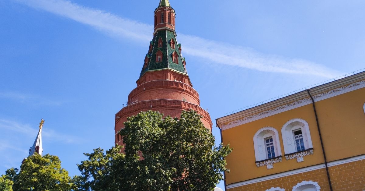 Tula Travel Guide: Kremlin Walls and Gingerbread Stories Low angle view of a historic Kremlin tower in Moscow, featuring architectural details and a clear blue sky.