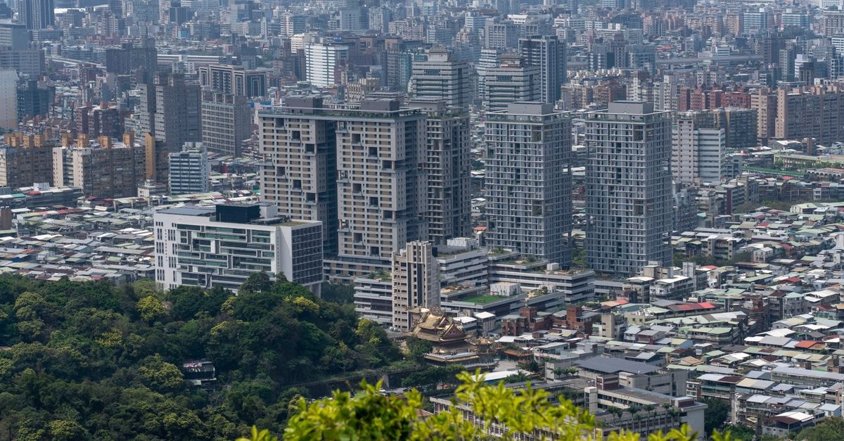 Aerial cityscape featuring dense skyscrapers and greenery, ideal for urban themes.