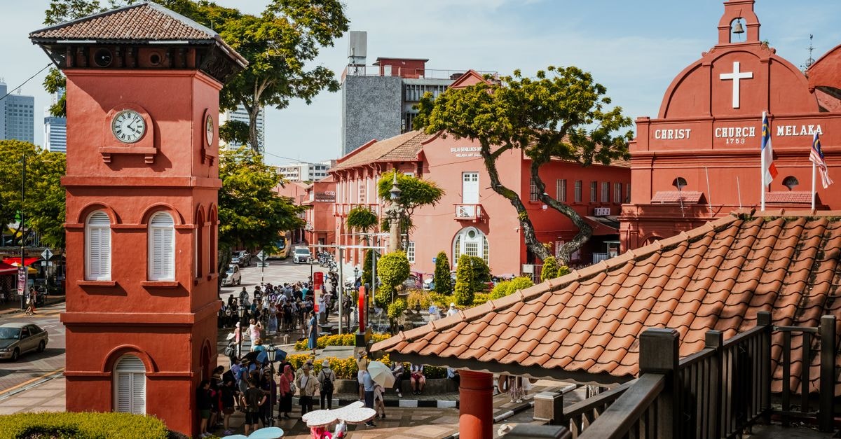 Regalo Hotel in Malacca: Budget Stay West of the Historic Core Vibrant scene of Malacca's iconic Christ Church and its bustling surroundings on a bright day.