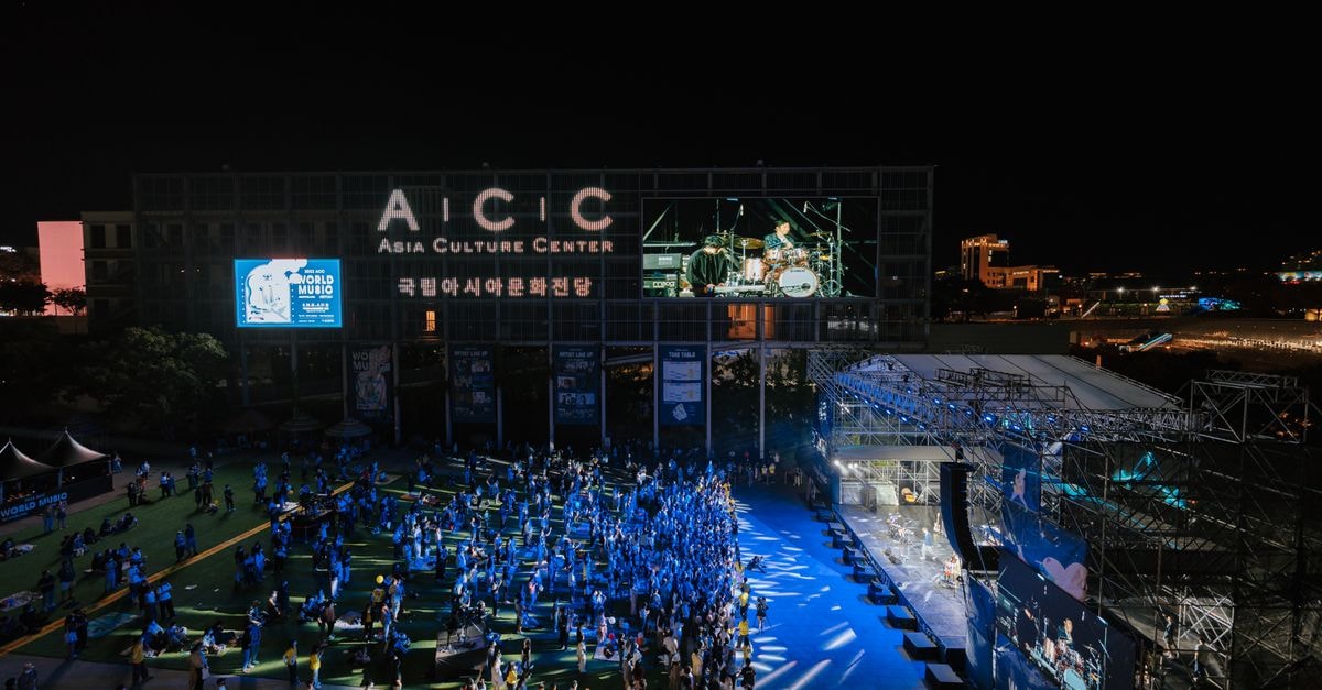 A vibrant night concert at Asia Culture Center with a lively crowd enjoying live music outdoors.