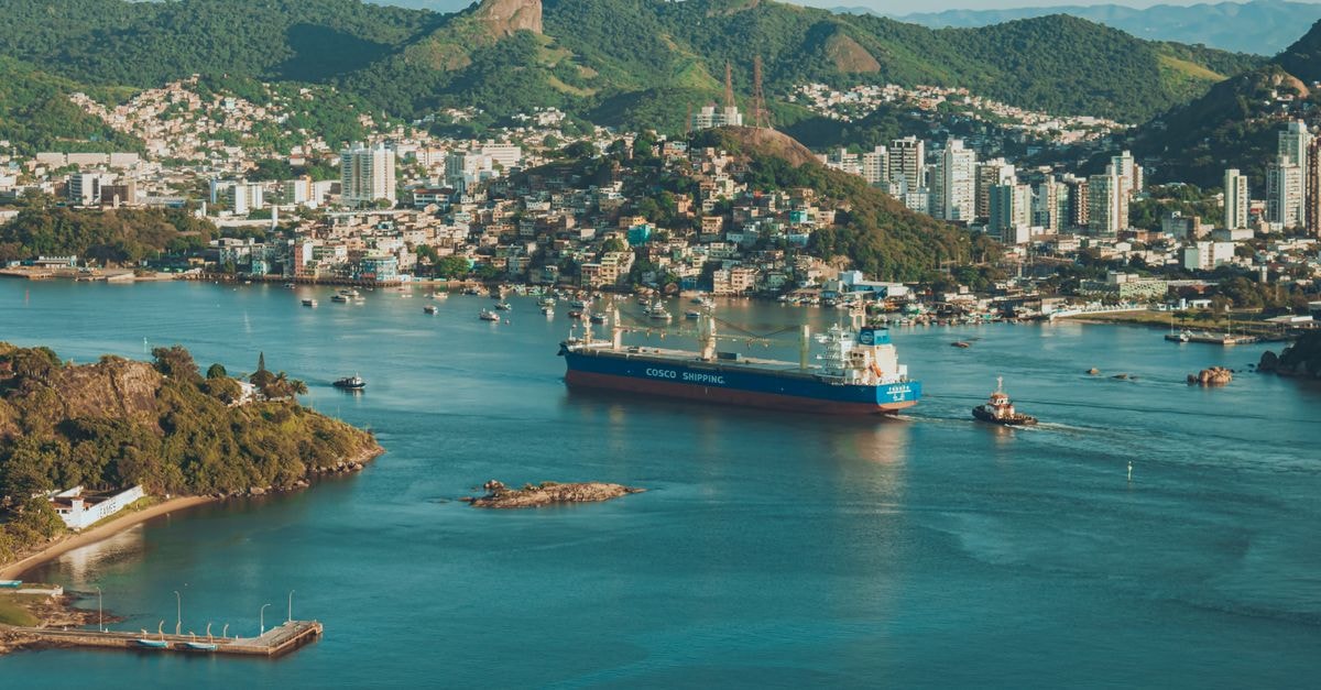 A stunning aerial view of Salvador harbor featuring a cargo ship and surrounding cityscape.