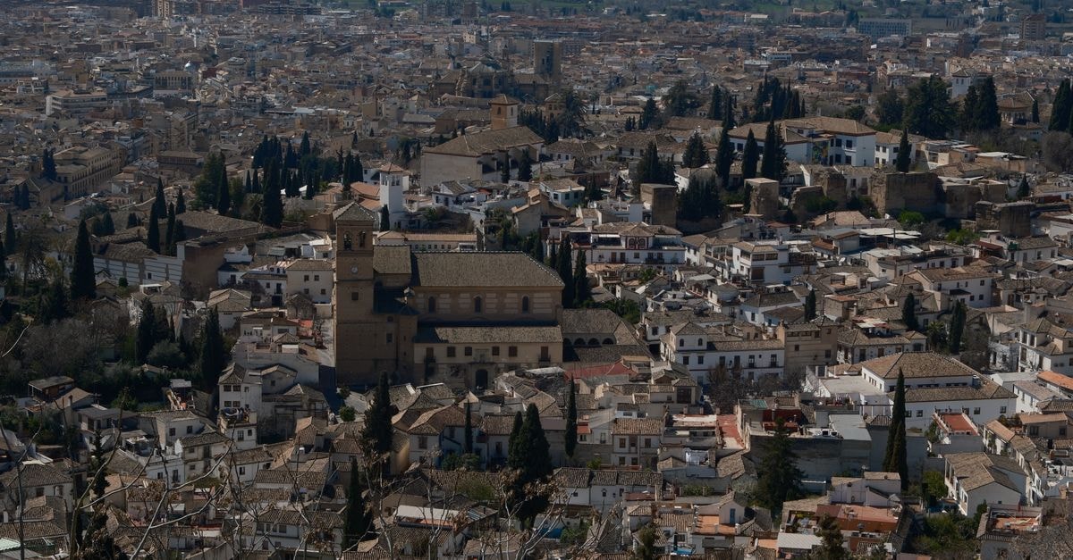 Aerial view of Granada's historic cityscape with iconic Alhambra architecture.