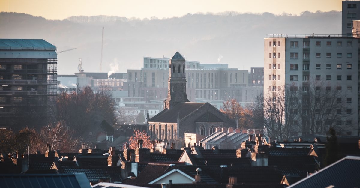 SUN1 Alberton in Germiston: Budget Stop Near Alberton City Shopping Centre Urban view of Bristol featuring St Luke's Church amidst city buildings during a serene sunset.
