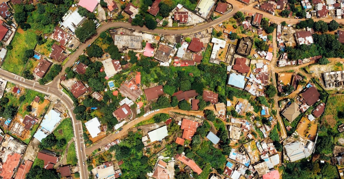 Elbo Suites in Brazzaville: Riverside Refinement on the Congo Top-down aerial view showcasing colorful urban landscape with diverse architecture.