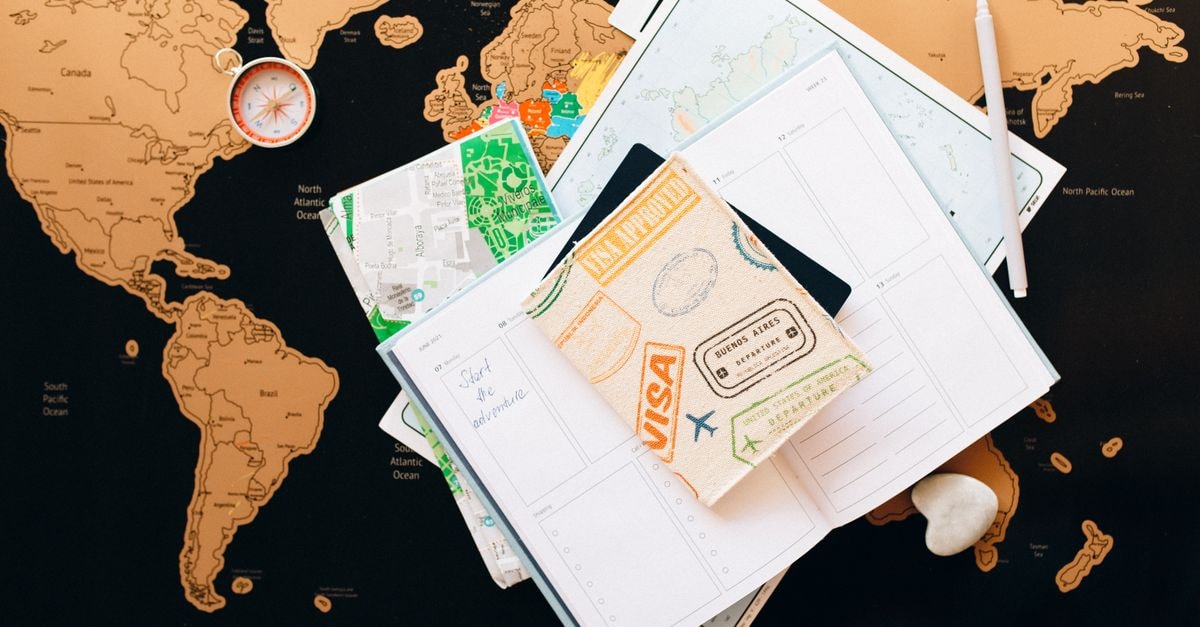 Montgomery Travel Guide: Planning Tips, Costs and Things to Do A flat lay of travel planning items on a map, featuring a compass, notebook, and guide for wanderlust enthusiasts.