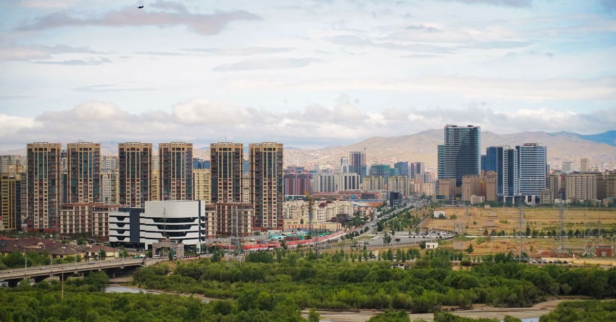 67 параллель in Naryan-Mar: Polyarnaya Street Boutique-Style Stay Panoramic view of Ulaanbaatar's urban skyline and lush landscape under a cloudy sky.