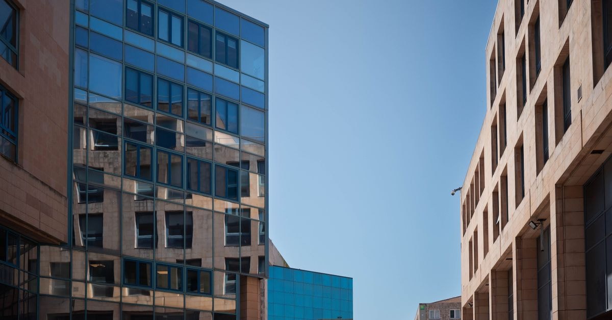 Modern office buildings reflecting each other in Toulon, France, captured on a clear day.