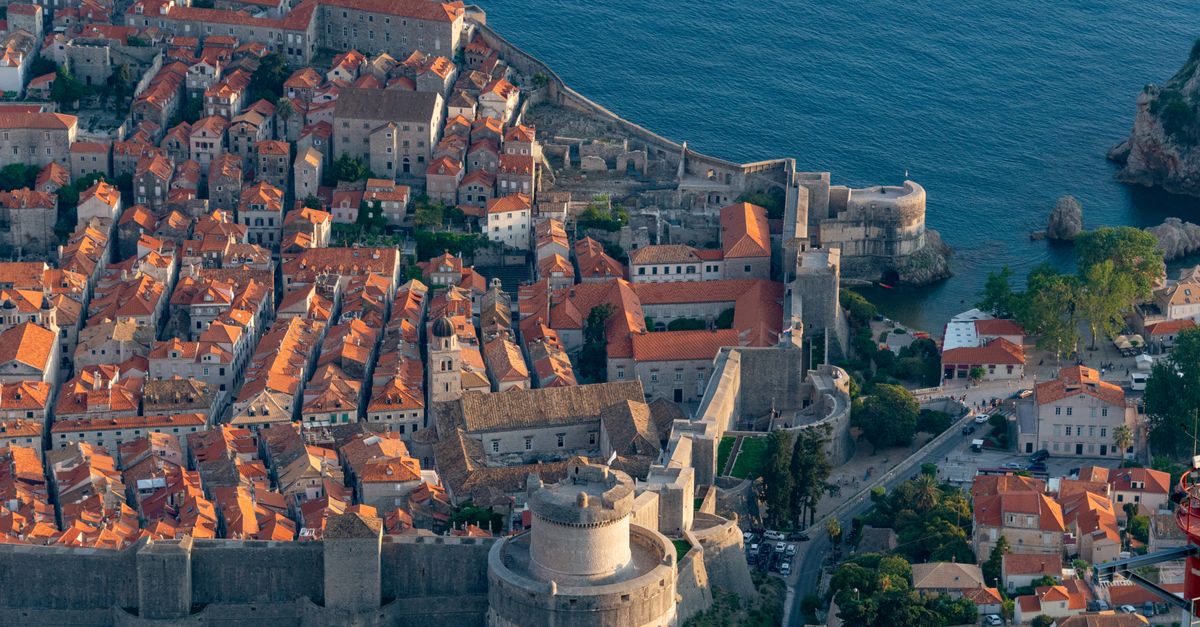 Dubrovnik Travel Guide for July 2026: Heat, Walls and Festival Crowds Stunning aerial view of the historic Dubrovnik Old Town and its city walls by the Adriatic Sea.