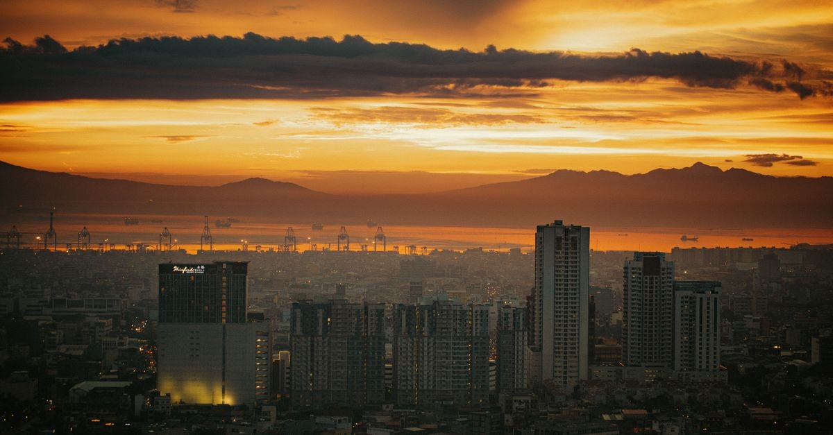 Breathtaking view of Manila's skyline at sunset, showcasing vibrant colors and cityscape.
