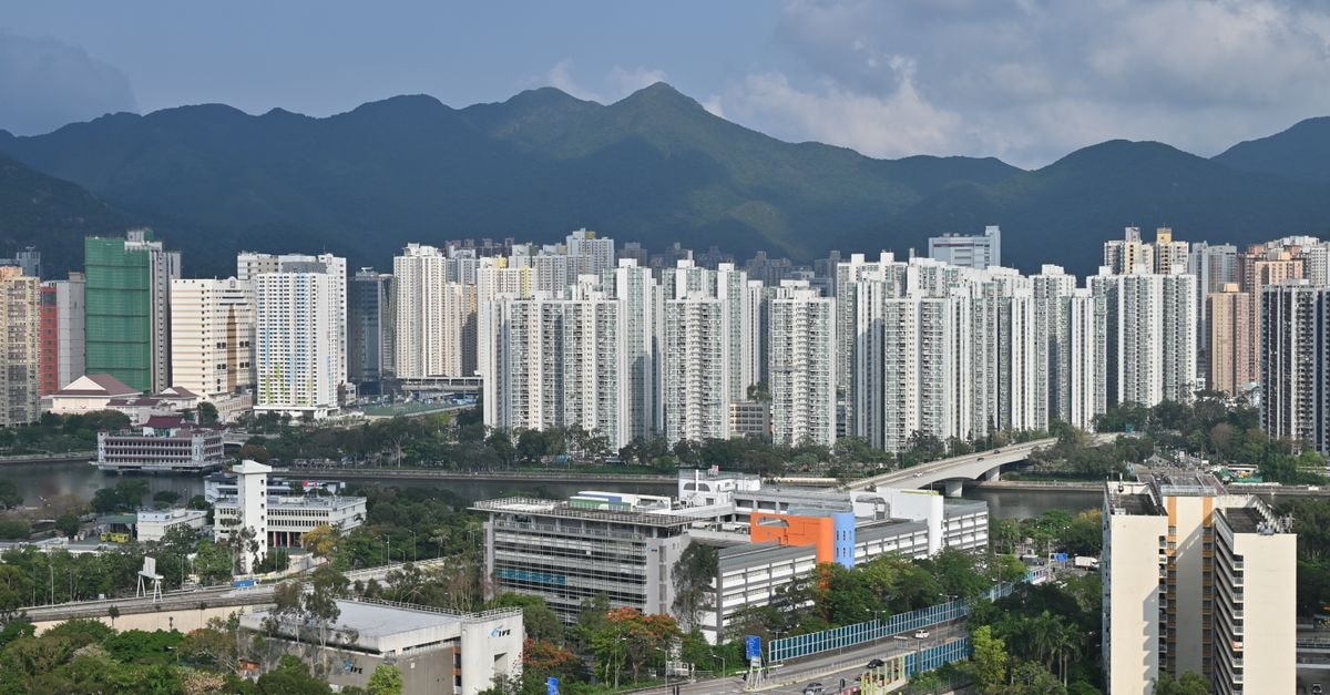 Yuen Long Travel Guide: Planning Tips, Costs and Things to Do Aerial photograph of Hong Kong's Sha Tin residential district with mountains in the background.