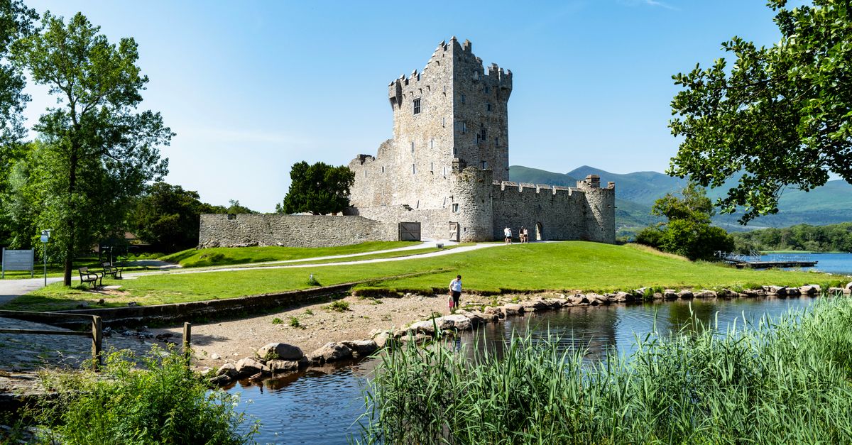 Killarney Travel Guide: Things to Do in Ireland's Lakeside Town in July 2026 Stunning view of Ross Castle by the lakeside in Killarney, Ireland.