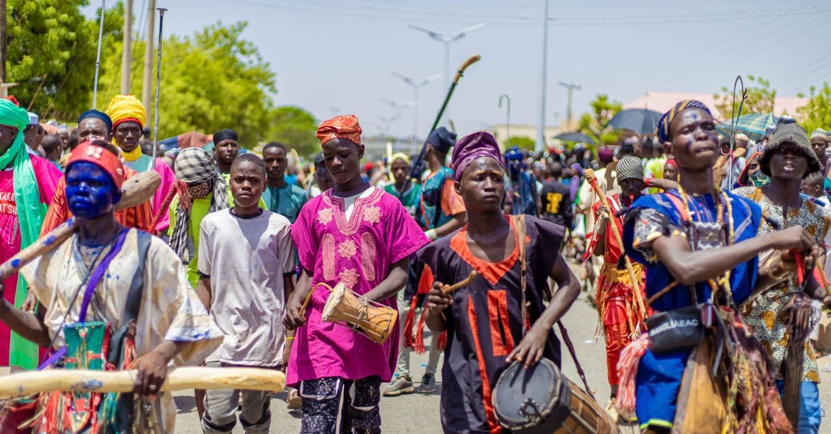 Wau travel guide: a quiet crossroads of South Sudan Colorful cultural festival with musicians and dancers in traditional attire on a bright day.